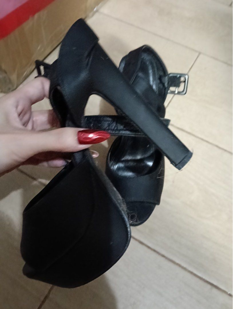 Shein Black High Heel Sandals with Ankle Strap (Category: Heels) located in Manila. Submitted by goddesssy (Listing ID 1467840983, Image 2). Description: - Color: Black - Material: Satin-like finish - Style: Open toe high heel sandals with platform soles - Heel: Sturdy block heel for added height and comfort - Closure: Adjustable buckle ankle strap - Occasion: Ideal for evening outings or formal events - Condition: Minor wear visible on the inner