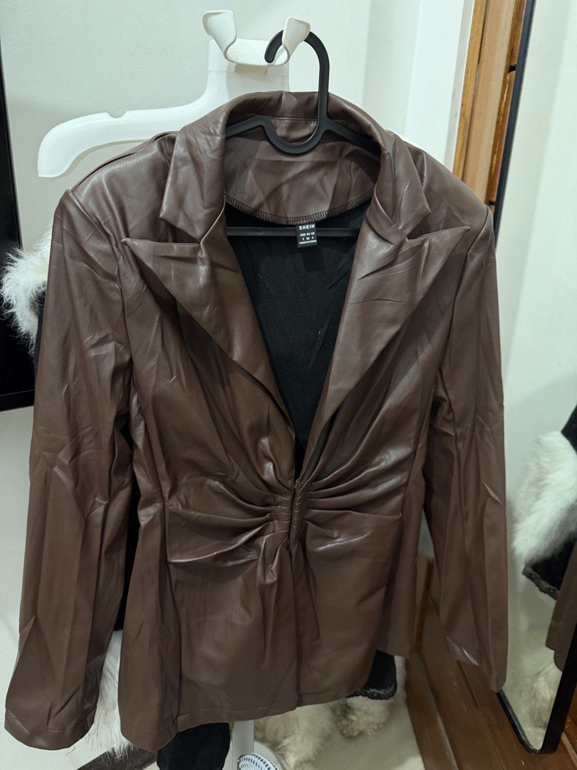 SHEIN Brown Faux Leather Blazer Jacket S (Category: Coats, Jackets and Outerwear) located in Makati City. Submitted by petite_preloved2 (Listing ID 1467841002, Image 2). Description: - Brand: SHEIN - Size: Small - Color: Neutral brown - Material: Faux leather - Design: Notched lapel, structured shoulders, tailored back panels, and gathered waist - Closure: Hook-and-eye front - Condition: Great layering piece for cooler weather.