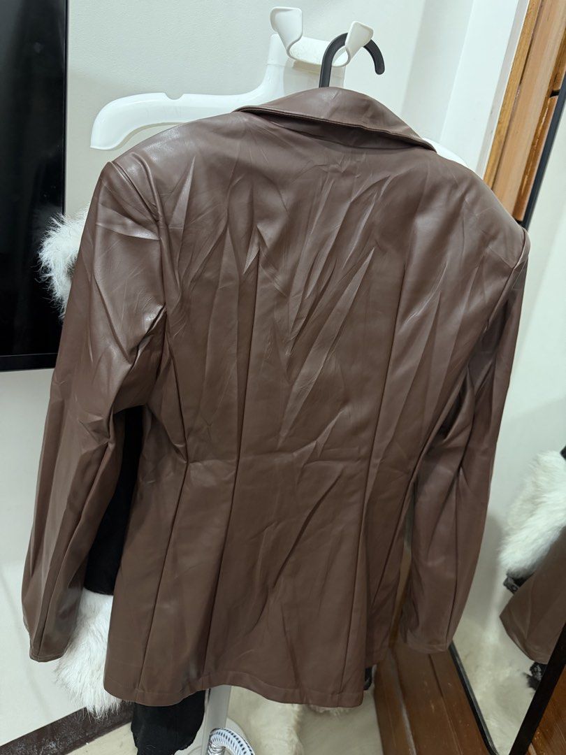 SHEIN Brown Faux Leather Blazer Jacket S (Category: Coats, Jackets and Outerwear) located in Makati City. Submitted by petite_preloved2 (Listing ID 1467841002, Image 3). Description: - Brand: SHEIN - Size: Small - Color: Neutral brown - Material: Faux leather - Design: Notched lapel, structured shoulders, tailored back panels, and gathered waist - Closure: Hook-and-eye front - Condition: Great layering piece for cooler weather.