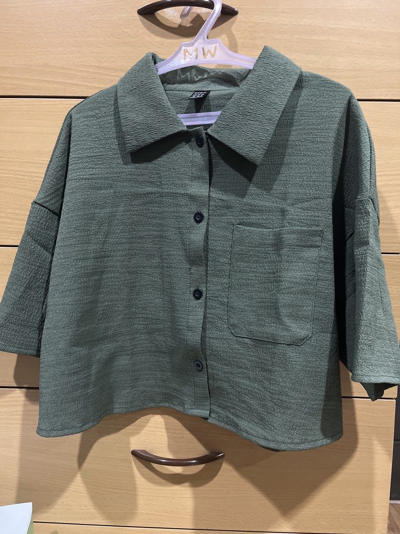 SHEIN Olive Green Button-Up Boxy Shirt (Category: Shirts) located in Quezon City. Submitted by zinniemon (Listing ID 1467904285, Image 1). Description: - Color: Olive Green - Fit: Short, cropped boxy cut with dropped shoulders - Sleeves: Elbow-length - Details: Textured fabric, front chest pocket, classic pointed collar, dark front buttons - Style: Casual, perfect for everyday wear - Condition: Excellent / Like new.