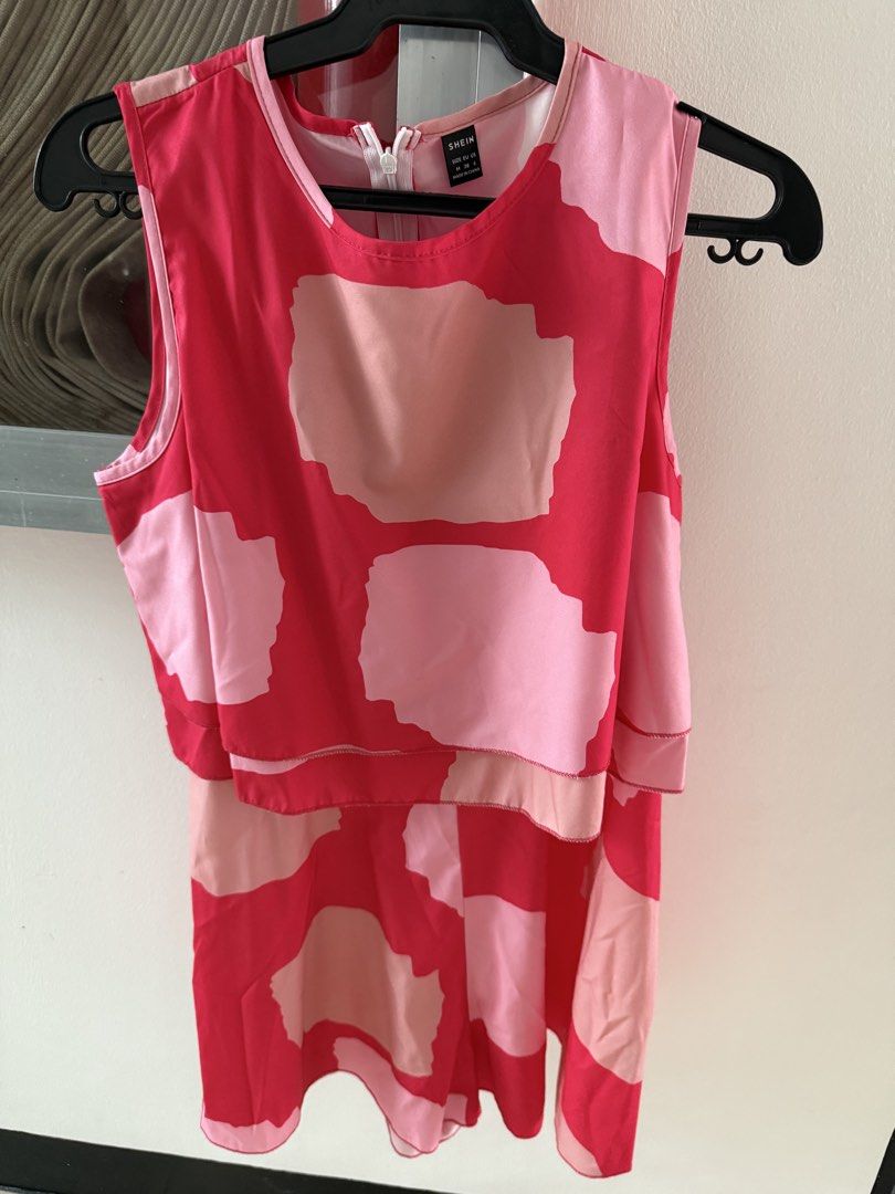 SHEIN Pink Abstract Print Layered Romper Size M (Category: Rompers) located in Mandaluyong City. Submitted by declutteringmylife101 (Listing ID 1467890411, Image 2). Description: - Brand: SHEIN - Size: Medium (M) - Design: Abstract block pattern in red, pink, and peach with a chic layered top - Style: Sleeveless with a back zipper closure - Material: Lightweight fabric, ideal for warm weather - Condition: Excellent.