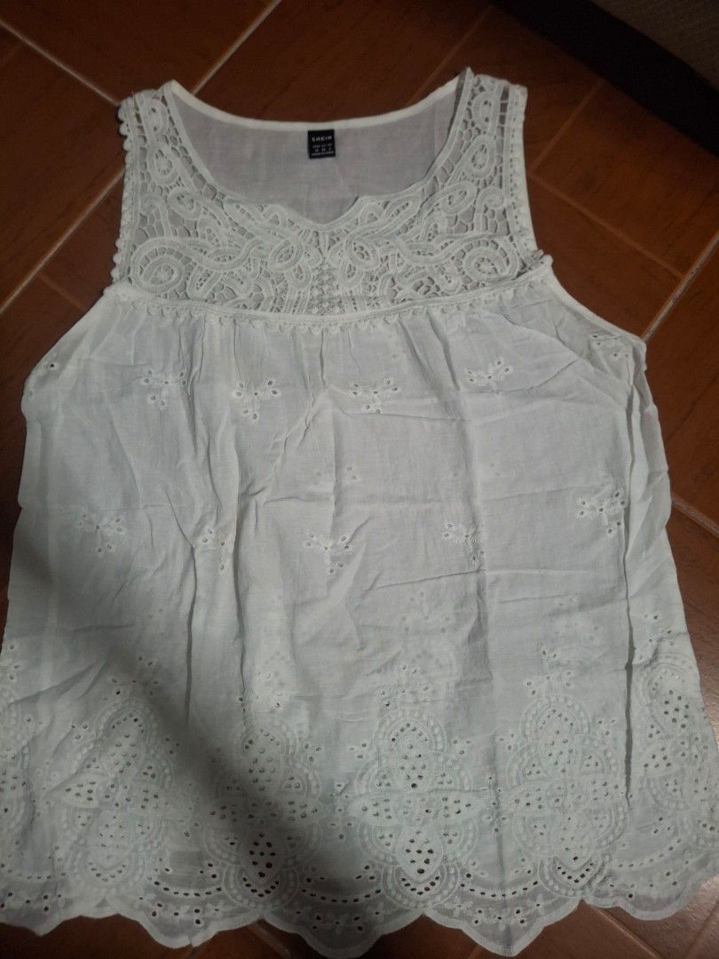 Shein White Lace Tank Top Size M (Category: Sleeveless) located in Plaridel. Submitted by niannyyy (Listing ID 1467970105, Image 1). Description: - Brand: Shein - Size: M (EU 38, US 6) - Color: White - Material: Lightweight and breathable fabric - Design: Intricate lace panel on chest and shoulders, scalloped hem with eyelet embroidery - Condition: Great for warm weather, easy to match with jeans or shorts - Origin: Made in China.