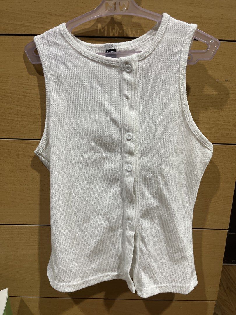 SHEIN White Ribbed Button-Down Tank Top (Category: Sleeveless) located in Quezon City. Submitted by zinniemon (Listing ID 1467902062, Image 1). Description: - Color: White - Design: Ribbed knit texture with subtle sparkle thread - Details: Front button placket with matching white buttons, classic round neckline, sleeveless - Fit: Fitted cut - Condition: Clean, tag intact, ready to wear - Perfect for: Casual daily outfits.