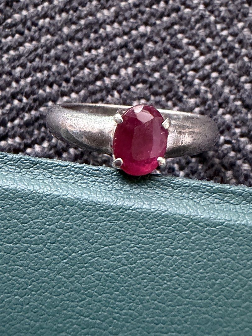 Silver Ring With Ruby Gemstone (Category: Rings) located in Singapore. Submitted by car12927 (Listing ID 1467903079, Image 1). Description: - Classic silver ring featuring a vibrant oval red gemstone - Size: Approximately 1 cm inner diameter - Secure prong setting keeps the stone firmly in place - Charming vintage appeal with visible metal wear and natural patina - Simple, timeless design perfect for everyday wear.