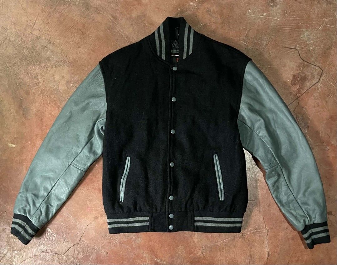 Sledwise Black Wool and Grey Leather Varsity Jacket (Category: Coats, Jackets and Outerwear) located in Gumaca. Submitted by makuliti (Listing ID 1467956905, Image 1). Description: - Brand: Sledwise - Style: Classic letterman / varsity jacket - Material: Black wool body with premium grey leather sleeves - Closure: Front snap buttons - Pockets: Matching front welt pockets - Details: Ribbed collar, cuffs, and hem with grey stripe accents - Construc
