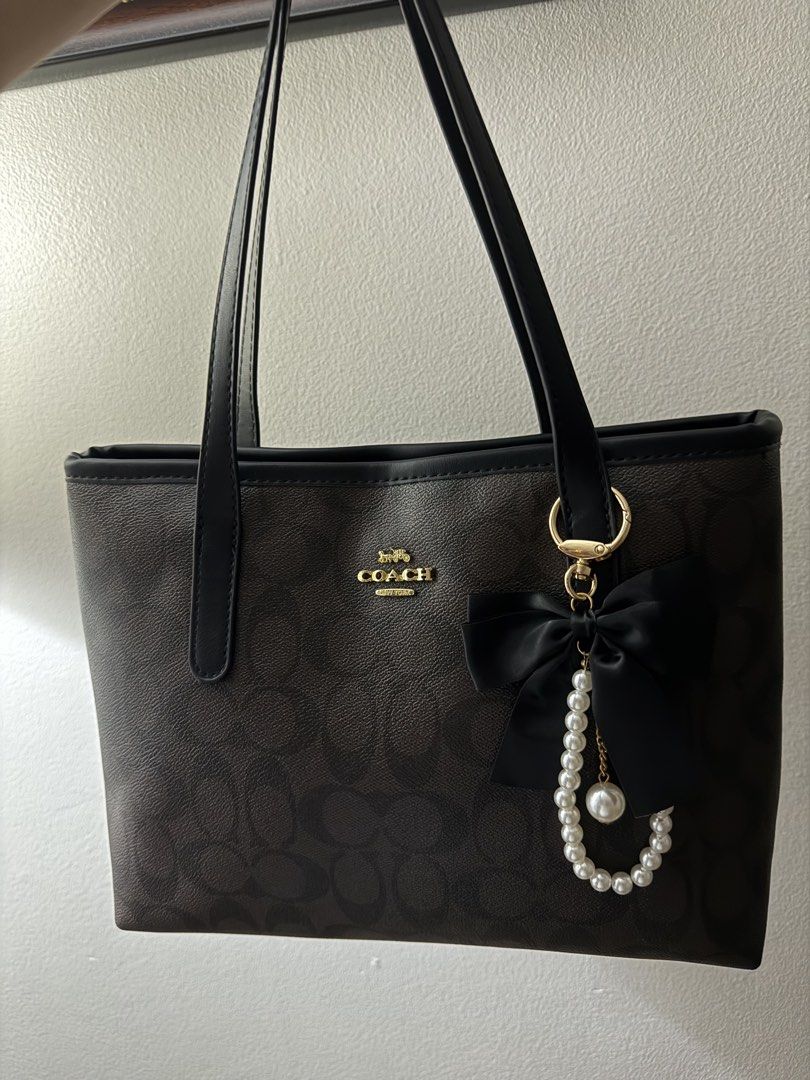 Small City Tote (Category: Tote Bags) located in Manila. Submitted by miksii_. (Listing ID 1467906114, Image 3). Description: - Brand: Coach - Material: Coated canvas with signature monogram print (Dark Brown/Black) - Straps: Dual black leather shoulder straps with gold-tone hardware - Interior: Clean lining, perfect for daily essentials - Condition: Excellent, ready to use - Negotiable.