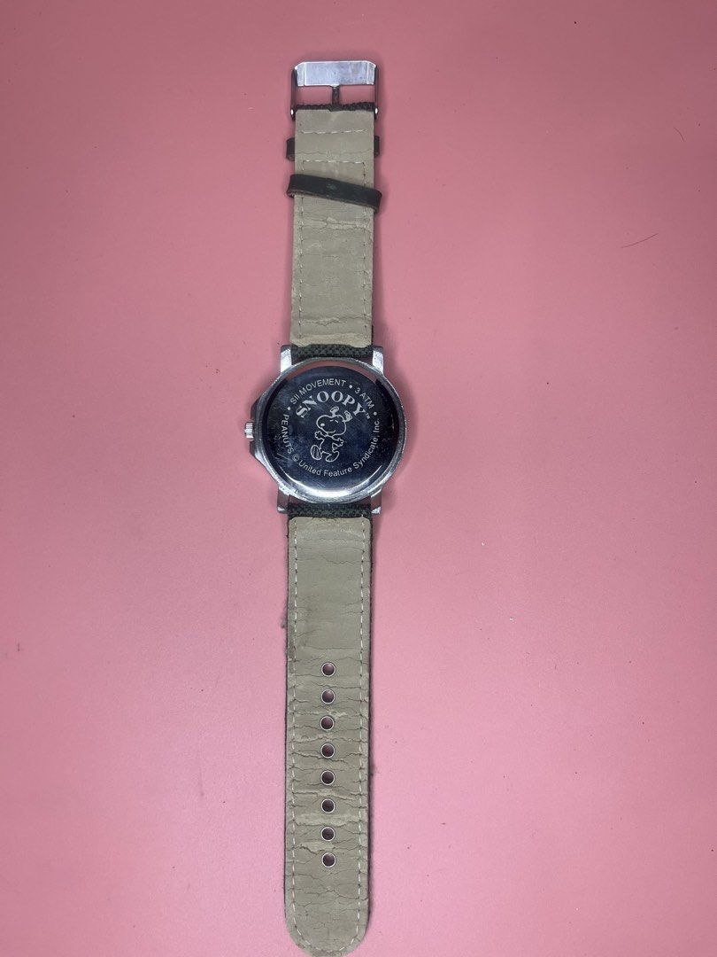 Snoopy Peanuts Analog Wristwatch with Canvas Strap (Category: Women's Watches) located in Caloocan City. Submitted by snapshop_ph (Listing ID 1468055472, Image 3). Description: - Authentic Peanuts Snoopy wristwatch with silver-tone dial (features numbers 3, 9, 12) - Dark canvas outer strap with contrast red stitching and metal buckle - Note: Beige inner lining shows significant cracking and wear - Powered by reliable SII Movement, 3 ATM water res