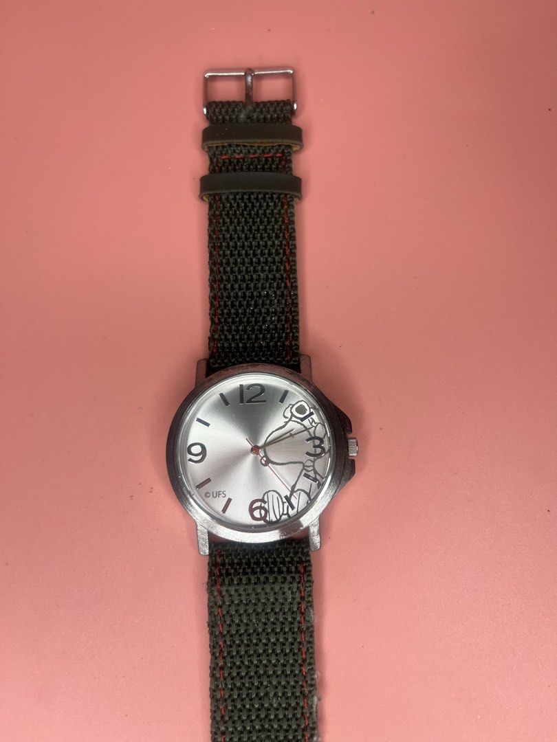 Snoopy Peanuts Analog Wristwatch with Canvas Strap (Category: Women's Watches) located in Caloocan City. Submitted by snapshop_ph (Listing ID 1468055472, Image 2). Description: - Authentic Peanuts Snoopy wristwatch with silver-tone dial (features numbers 3, 9, 12) - Dark canvas outer strap with contrast red stitching and metal buckle - Note: Beige inner lining shows significant cracking and wear - Powered by reliable SII Movement, 3 ATM water res