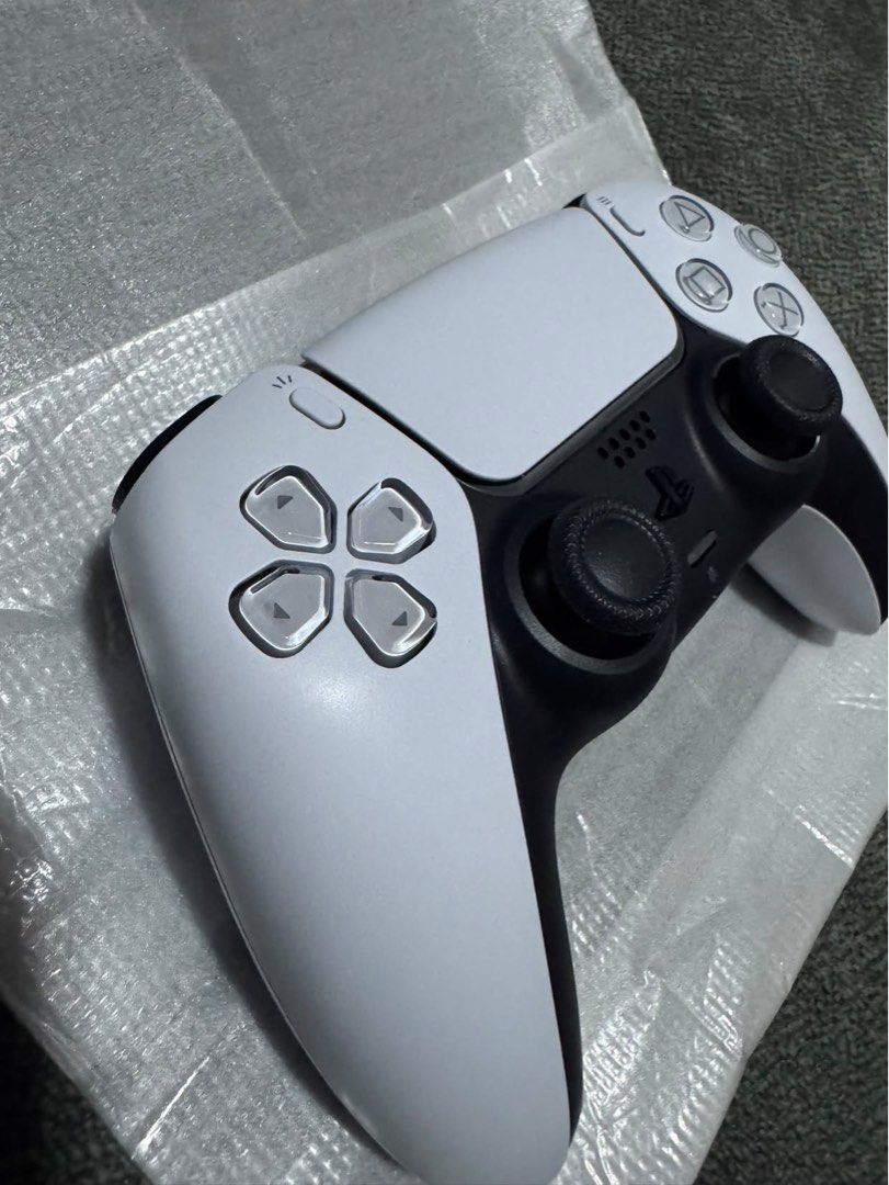 Sony PlayStation 5 DualSense Wireless Controller White (Category: Controllers) located in Makati City. Submitted by muffinstuffins (Listing ID 1467991459, Image 2). Description: - Authentic Sony PlayStation 5 wireless controller (Model: CFI-ZCT1G) - Classic white and black colorway with clean exterior housing - Standard layout featuring dual analog sticks, D-pad, and action buttons - Textured grip on thumbsticks for better control and comfort - F