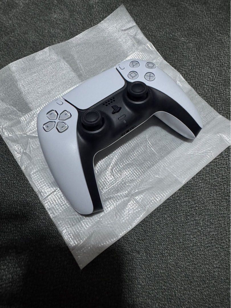 Sony PlayStation 5 DualSense Wireless Controller White (Category: Controllers) located in Makati City. Submitted by muffinstuffins (Listing ID 1467991459, Image 1). Description: - Authentic Sony PlayStation 5 wireless controller (Model: CFI-ZCT1G) - Classic white and black colorway with clean exterior housing - Standard layout featuring dual analog sticks, D-pad, and action buttons - Textured grip on thumbsticks for better control and comfort - F