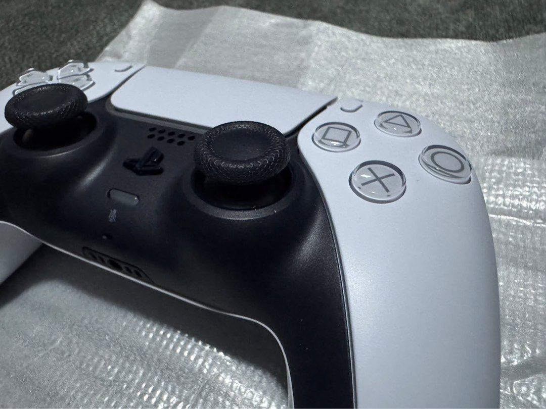 Sony PlayStation 5 DualSense Wireless Controller White (Category: Controllers) located in Makati City. Submitted by muffinstuffins (Listing ID 1467991459, Image 3). Description: - Authentic Sony PlayStation 5 wireless controller (Model: CFI-ZCT1G) - Classic white and black colorway with clean exterior housing - Standard layout featuring dual analog sticks, D-pad, and action buttons - Textured grip on thumbsticks for better control and comfort - F
