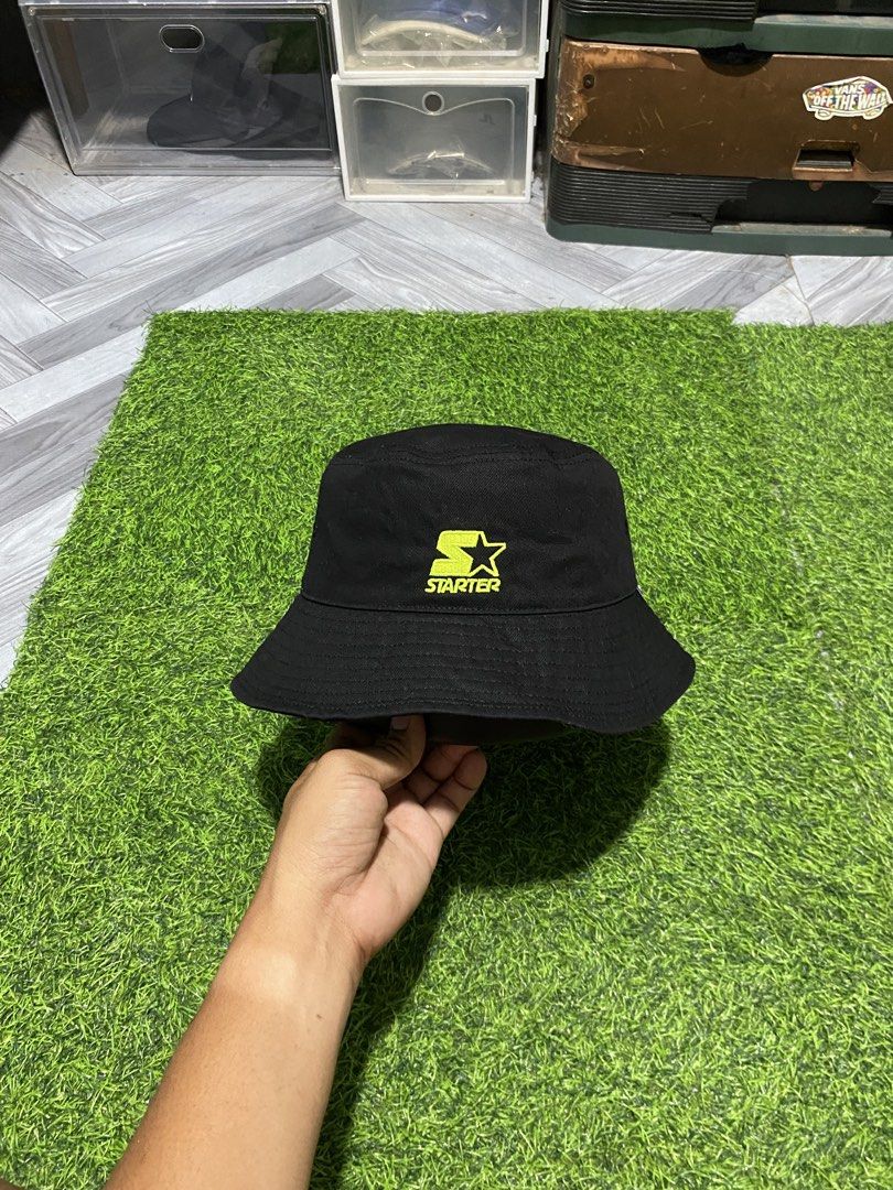 Starter Black Label Black Bucket Hat (Category: Caps & Hats) located in Polomolok. Submitted by marrssz (Listing ID 1467947992, Image 1). Description: - Brand: Starter Black Label - Color: Solid black with a bright neon yellow embroidered logo - Material: 100% durable cotton canvas - Interior: Features branded internal tape and clean lining - Condition: Brand new with tags and care instructions attached -MEDIUM LARGE HEAD -56-58 CM.