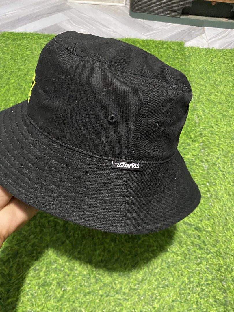 Starter Black Label Black Bucket Hat (Category: Caps & Hats) located in Polomolok. Submitted by marrssz (Listing ID 1467947992, Image 3). Description: - Brand: Starter Black Label - Color: Solid black with a bright neon yellow embroidered logo - Material: 100% durable cotton canvas - Interior: Features branded internal tape and clean lining - Condition: Brand new with tags and care instructions attached -MEDIUM LARGE HEAD -56-58 CM.