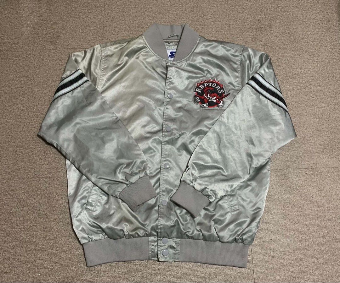Starter Toronto Raptors Satin Bomber Jacket Grey XL (Category: Coats, Jackets and Outerwear) located in Tagum. Submitted by knilevinc69480 (Listing ID 1468006397, Image 1). Description: - Authentic Vintage Starter Toronto Raptors satin jacket - Color: Silver grey with black and white striped ribbed trim - Size: XL (Made in Vietnam) - Features: Snap button closure, embroidered team chest logo, and signature Star sleeve patch - Storage: Convenient 