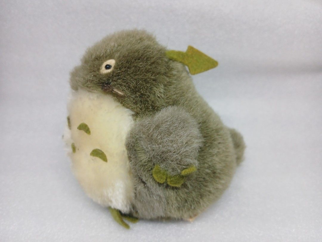 Studio Ghibli Totoro Green Leaf Plush Toy (Category: Plushies & Soft Toys) located in Pila. Submitted by Yela.ph_1 (Listing ID 1467946188, Image 3). Description: - Adorable green Totoro-inspired plush toy - Fluffy grey-green fur with a soft cream belly - Features cute green felt chest markings and a small leaf on the head - Designed with a soft round body, small limbs, and a fuzzy tail - Perfect collectible piece for Studio Ghibli fans - Conditio