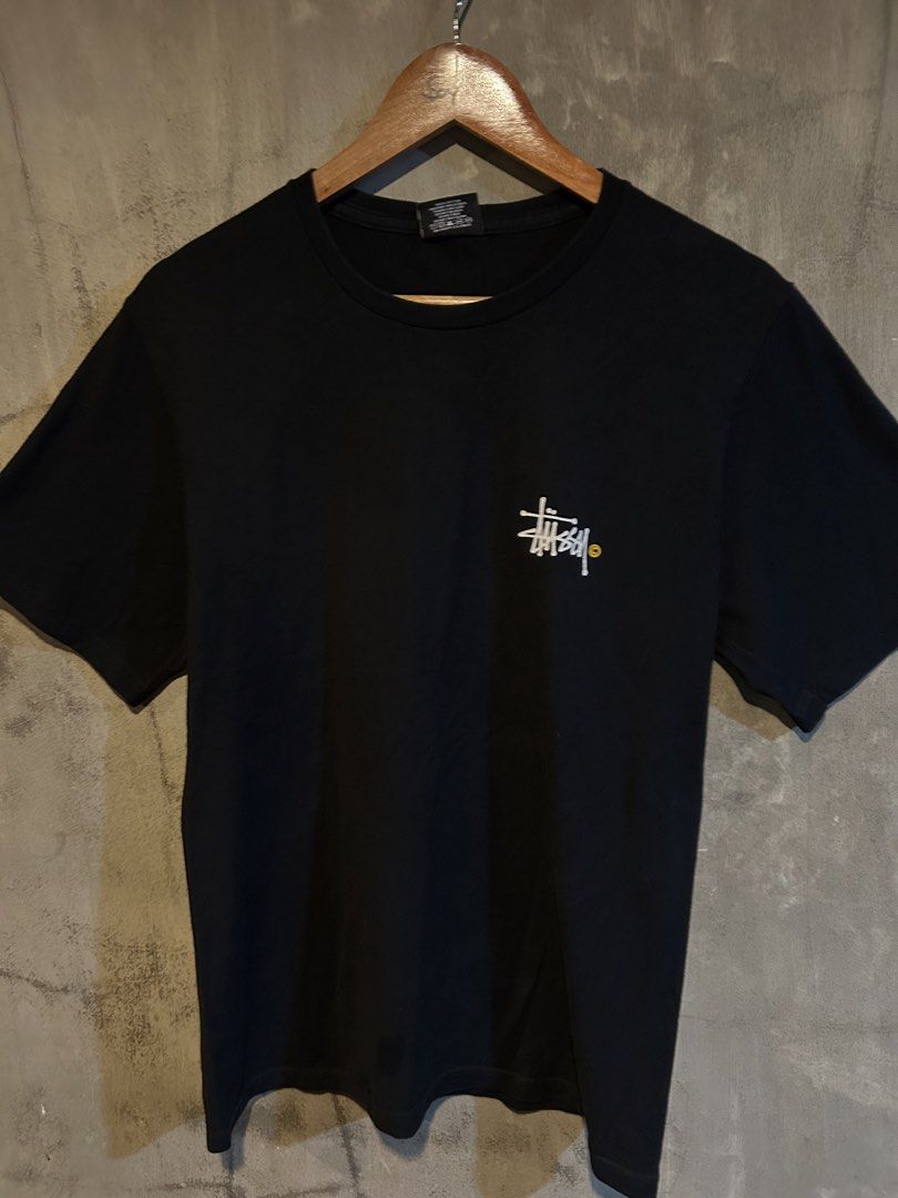 Stussy Black T-Shirt Small (Category: Tshirts & Polo Shirts ) located in Manila. Submitted by jayson221 (Listing ID 1468002916, Image 1). Description: Brand: Stüssy Dimes W:18.5 L:27 good condition Issue: minimal hairline 9.9/10 color rate - Color: Black with white logos - Size: Small (Made in Mexico) - Design: Small chest logo and large back graphic with yellow copyright symbol - Condition: Solid pre-loved condition with minor cracking on the ba