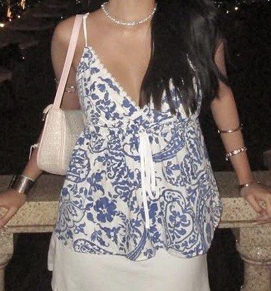 summer blue white toile patterned floral cami top (Category: Sleeveless) located in Quezon City. Submitted by kalmai (Listing ID 1467930294, Image 3). Description: - Color & Pattern: Blue and white floral - Neckline: V-neck with delicate lace trim - Waist: Smocked elastic with functional front drawstring tie - Straps: Adjustable/light spaghetti straps - Details: Eyelet cutout patterns and a soft peplum hem - Condition/Vibe: Great breezy piece for