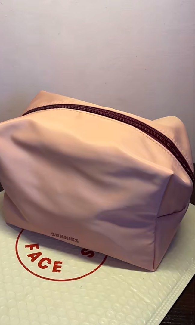 Sunnies Face Everyday Pouch (Category: Purses & Pouches) located in Manila. Submitted by graceeeeee_ (Listing ID 1467896363, Image 2). Description: - Brand: Sunnies Face - Item: Everyday Pouch - Features: Roomy design, top zipper closure, branded label on front - Condition: Clean interior and exterior, properly stored since unboxing - Perfect for makeup and daily essentials.