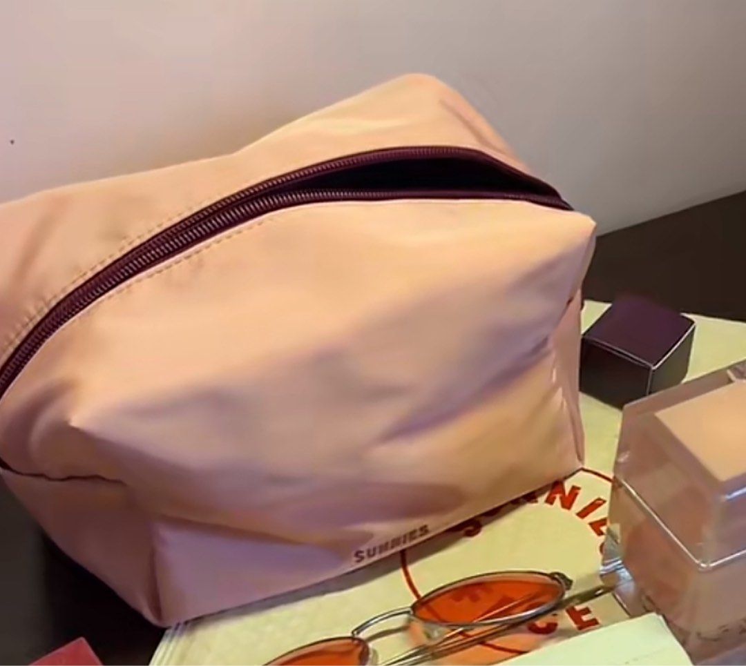 Sunnies Face Everyday Pouch (Category: Purses & Pouches) located in Manila. Submitted by graceeeeee_ (Listing ID 1467896363, Image 3). Description: - Brand: Sunnies Face - Item: Everyday Pouch - Features: Roomy design, top zipper closure, branded label on front - Condition: Clean interior and exterior, properly stored since unboxing - Perfect for makeup and daily essentials.