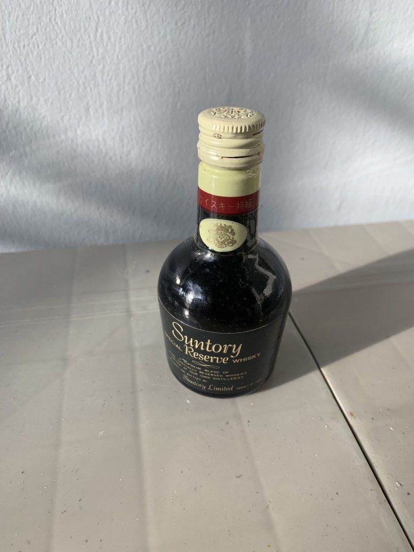 Suntory Reserve Whisky Miniature Bottle (Category: Vintage Collectibles) located in Taguig. Submitted by madisam (Listing ID 1467916927, Image 1). Description: - Item: Miniature Suntory Reserve Special Blend Japanese Whisky - Volume: 50ml - Design: Black glass body with elegant gold lettering and white screw cap - Authenticity: Bottom marked Suntory Ltd Liquor Bottle Japan - Condition: Perfect collector's piece for whisky enthusiasts.