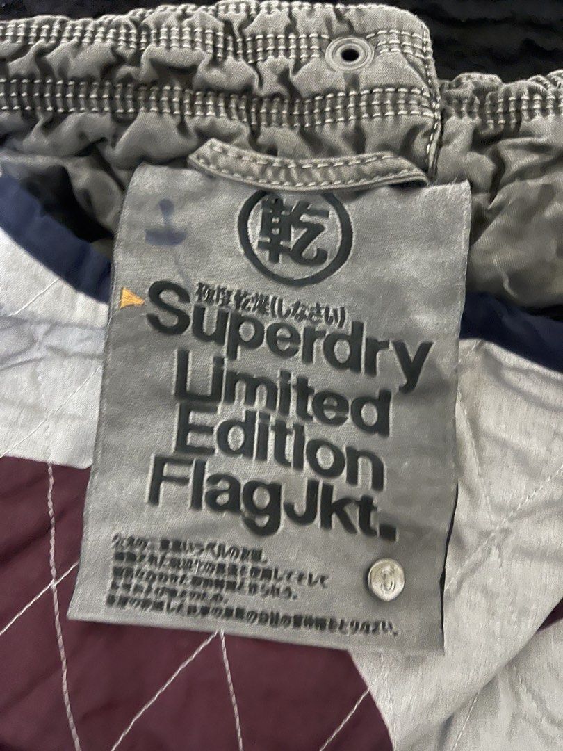 Superdry Limited Edition Flag Jacket Military Issue (Category: Coats, Jackets and Outerwear) located in La Trinidad. Submitted by potatothriftlip (Listing ID 1468057806, Image 3). Description: - Brand: Superdry - Style: Military Issue Limited Edition Flag Jacket - Color/Wash: Grey - Details: Mandarin regimental collar with snap buttons, metal hardware - Pockets: Multiple utility pockets for functionality - Waist: Adjustable drawstring with black 