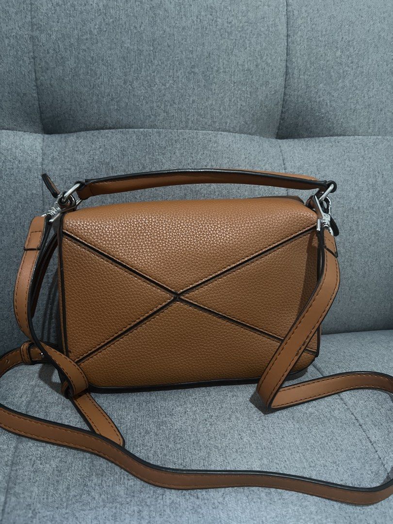 Tan Puzzle Bag Crossbody (Category: Cross-body Bags) located in Las Pinas. Submitted by erenrosc (Listing ID 1467915255, Image 2). Description: - Material & Finish: Premium tan leather with a stylish textured grain finish - Design: Distinct geometric panel design highlighted with chic black edge painting - Versatility: Comes with a sturdy top handle and an adjustable shoulder strap with sleek silver-tone hardware - Closure: Secure zip closure tuc