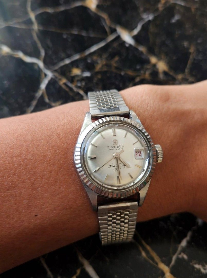 Technos Vintage Watch (Category: Women's Watches) located in Caloocan City. Submitted by chonadura91470 (Listing ID 1467916479, Image 3). Description: - Brand: technos vintage watch produce in the 60's and 70's - Movement: Automatic (winds smoothly) - Dial: Silver sunburst with fluted bezel - Date: 3 o'clock position with unique red numbers - Material: Stainless steel case with vintage mesh-style metal bracelet - Details: Sonnige stamped case bac
