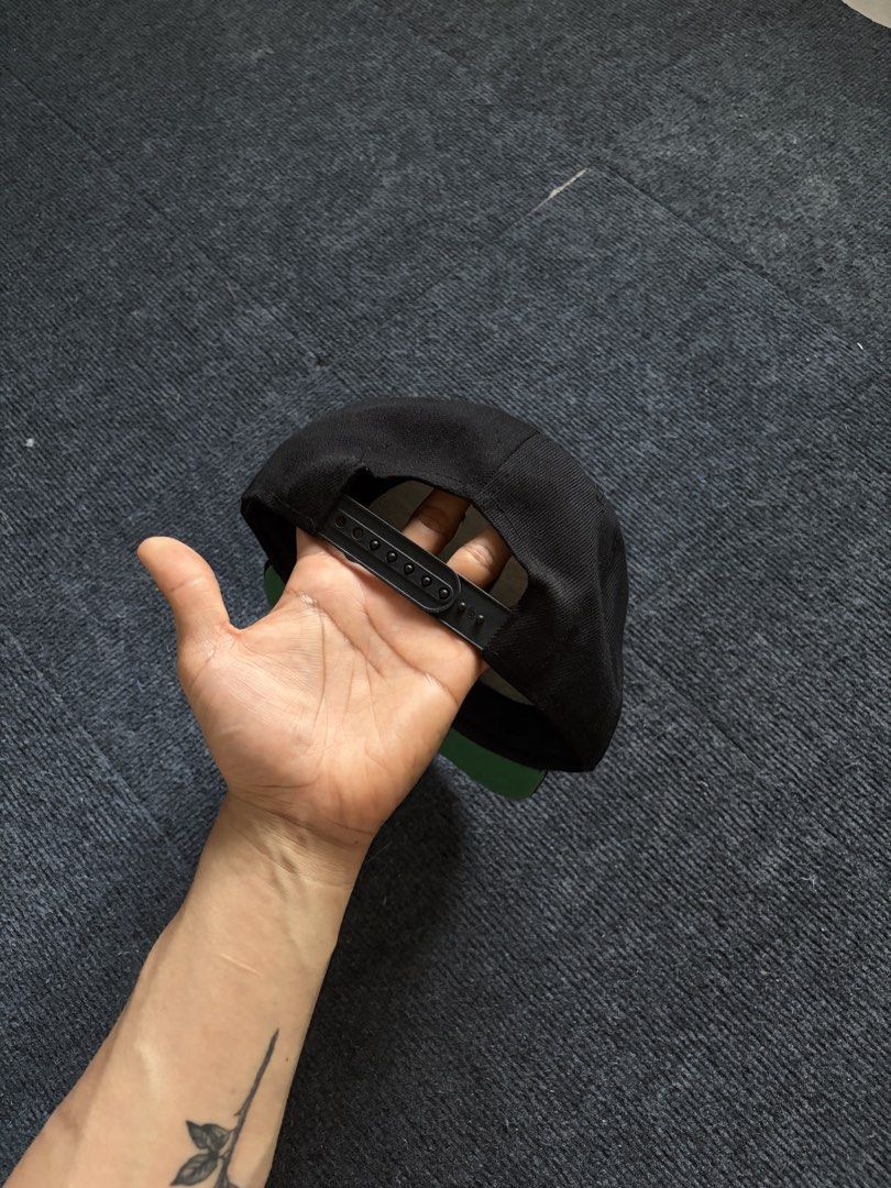 The Hundreds Snapback Hat Black Green Undervisor (Category: Caps & Hats) located in Manila. Submitted by toys_hats005 (Listing ID 1467955616, Image 2). Description: - Brand: The Hundreds - Color: Black with burgundy and yellow embroidered logo patch - Under brim: Classic green undervisor - Fit: Adjustable plastic snapback closure - Material: 80% acrylic, 20% wool - Condition: Clean interior lining with original brand tags intact.