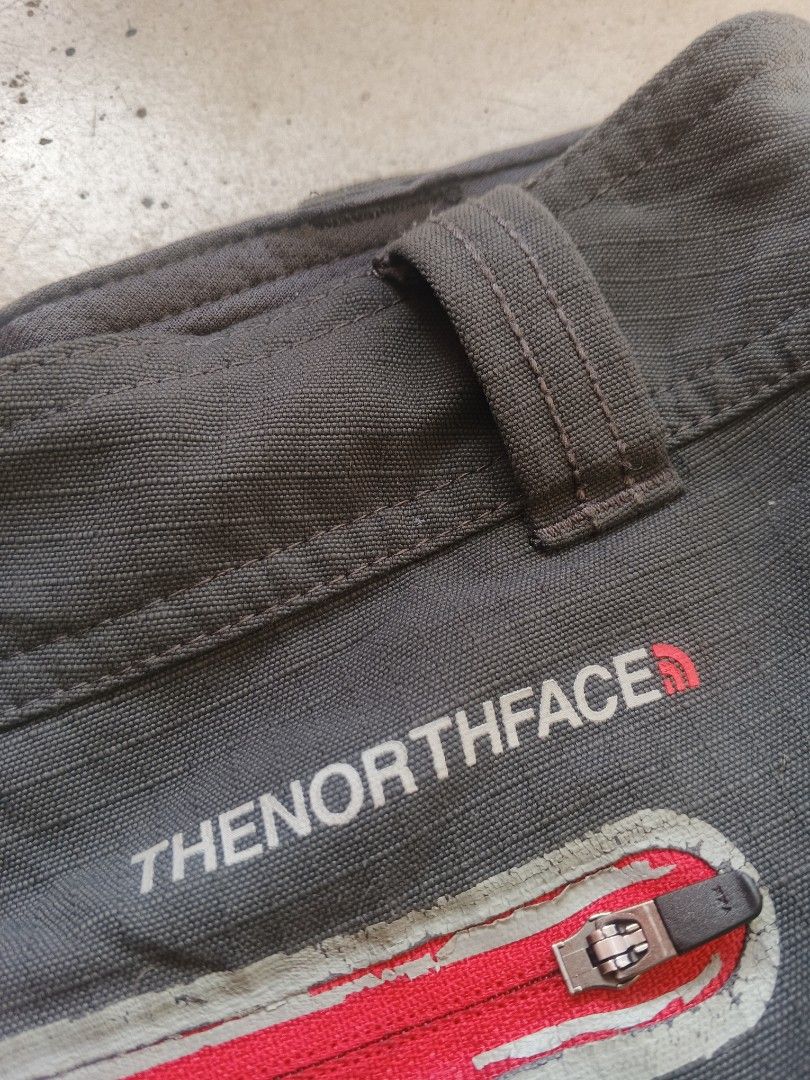 The North Face Cargo Shorts Dark Grey (Category: Shorts) located in Manila. Submitted by josephlim13 (Listing ID 1467846263, Image 3). Description: - Brand: The North Face - Color: Dark Grey - Material: 100% nylon ripstop fabric (ultra-durable) - Pockets: Multiple utility pockets plus a signature red-zipped back pocket and side cargo flaps - Details: Embroidered TNF logo near the back pocket, standard belt loops, and front button closure - Condit