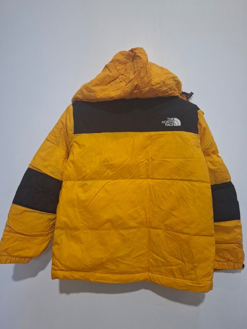 The North Face Yellow Black Puffer Jacket (Category: Babies & Kids Fashion) located in Imus. Submitted by maggieforce (Listing ID 1467870462, Image 2). Description: - has unnoticeable black stains on arm area, wrinkled specially on hood part - Brand: The North Face - Color: Bright yellow and black color block - Style: Puffer jacket with quilted design for maximum warmth - Features: Attached hood with drawstrings and zip front closure - Best for: 