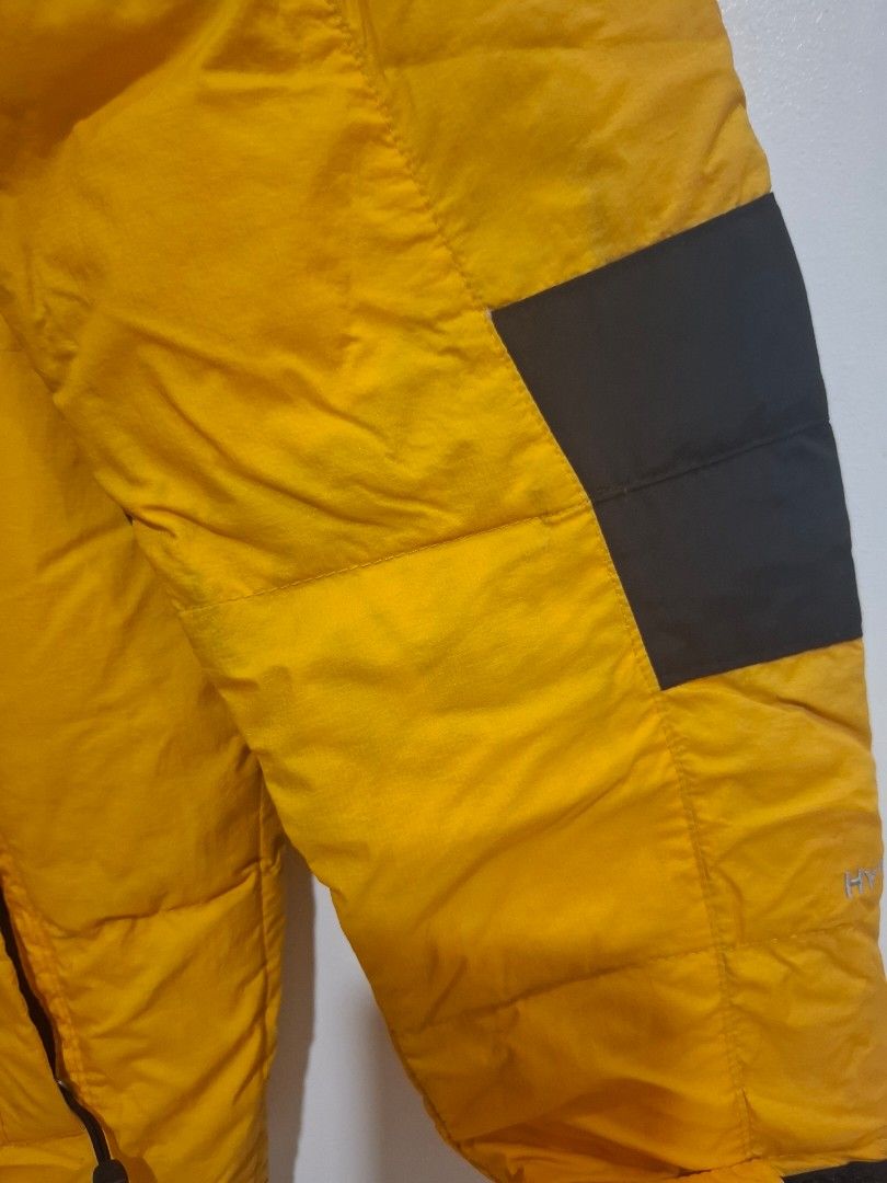 The North Face Yellow Black Puffer Jacket (Category: Babies & Kids Fashion) located in Imus. Submitted by maggieforce (Listing ID 1467870462, Image 3). Description: - has unnoticeable black stains on arm area, wrinkled specially on hood part - Brand: The North Face - Color: Bright yellow and black color block - Style: Puffer jacket with quilted design for maximum warmth - Features: Attached hood with drawstrings and zip front closure - Best for: 