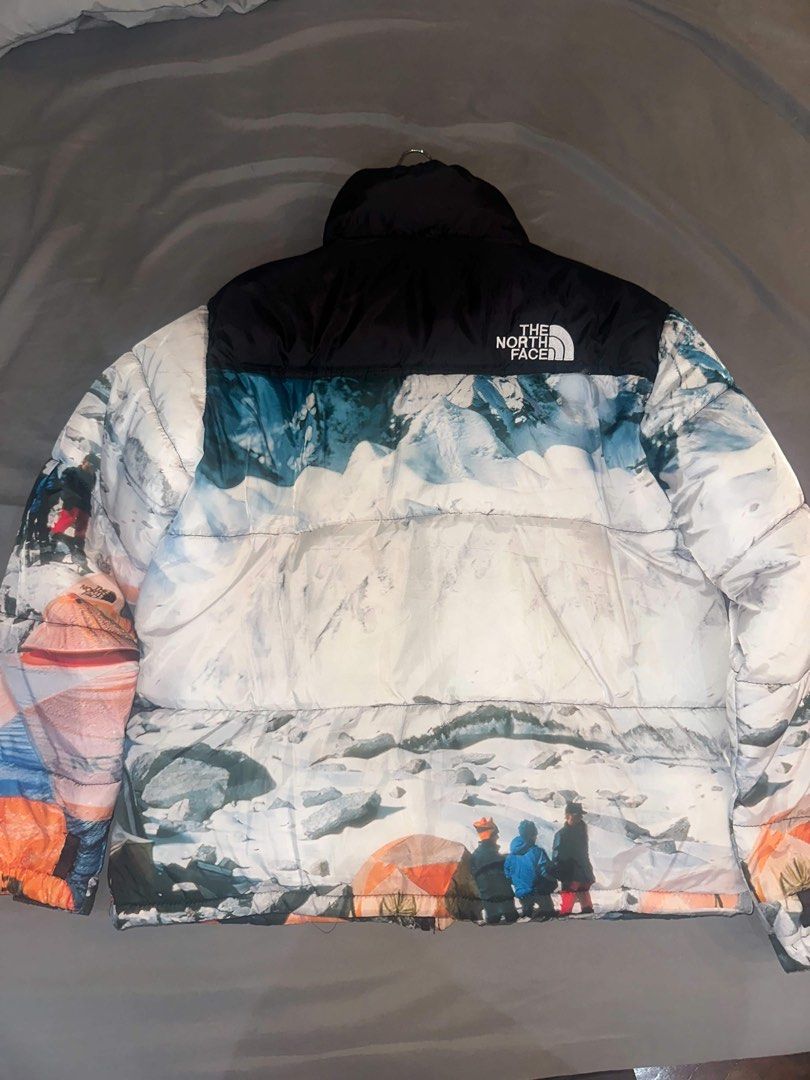 The North Face-Style Printed Puffer Jacket – XL (Category: Coats, Jackets and Outerwear) located in Quezon City. Submitted by ladymadness (Listing ID 1467889867, Image 2). Description: The North Face-Style Printed Puffer Jacket – XL Eye-catching multicolor puffer jacket featuring a unique mountain and camping print in blue, white, orange, and black. Details: Size: XL Color: Multicolor Style: Padded puffer jacket Full zip closure High collar Front
