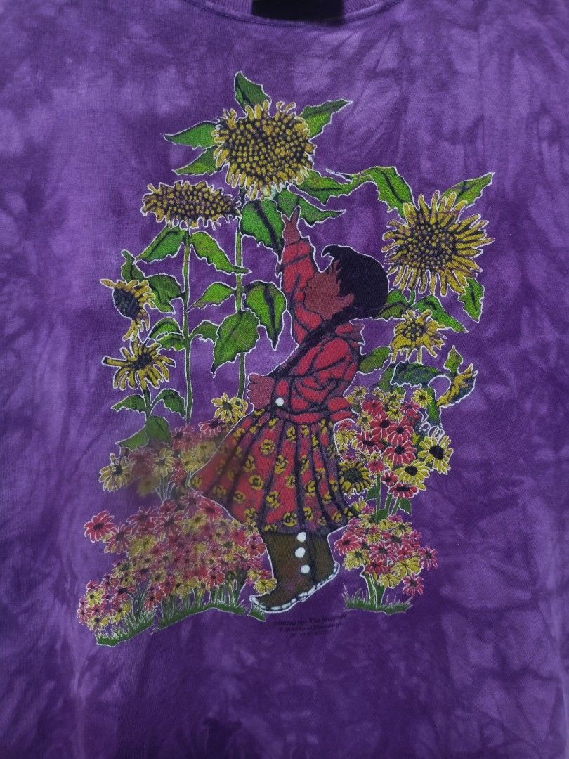 This vintage The Mountain (Category: Shirts) located in Rizal. Submitted by daddyjayofficialph (Listing ID 1467844680, Image 3). Description: This vintage purple tie-dye t-shirt features artwork by Lydia Dillion-Sutton, produced by The Mountain around 1996. Size: XL on Tag. dimes 20x25..