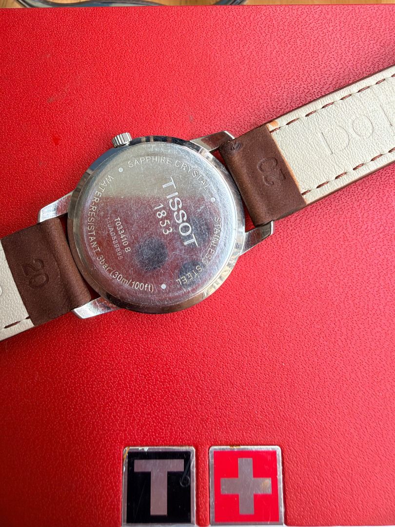 Tissot 1853 Classic Watch with Leather Strap (Category: Men's Watches) located in Quezon City. Submitted by 30somethingtreasures (Listing ID 1467991908, Image 3). Description: - Brand: Tissot 1853 - Dial: White with Roman numerals and 4 o'clock date window - Strap: Genuine brown leather - Case Back: Stainless steel (Ref: T033410B, water-resistant) - Inclusion: Original Tissot red and black box - Condition: Well-maintained and ready to wear - Meet