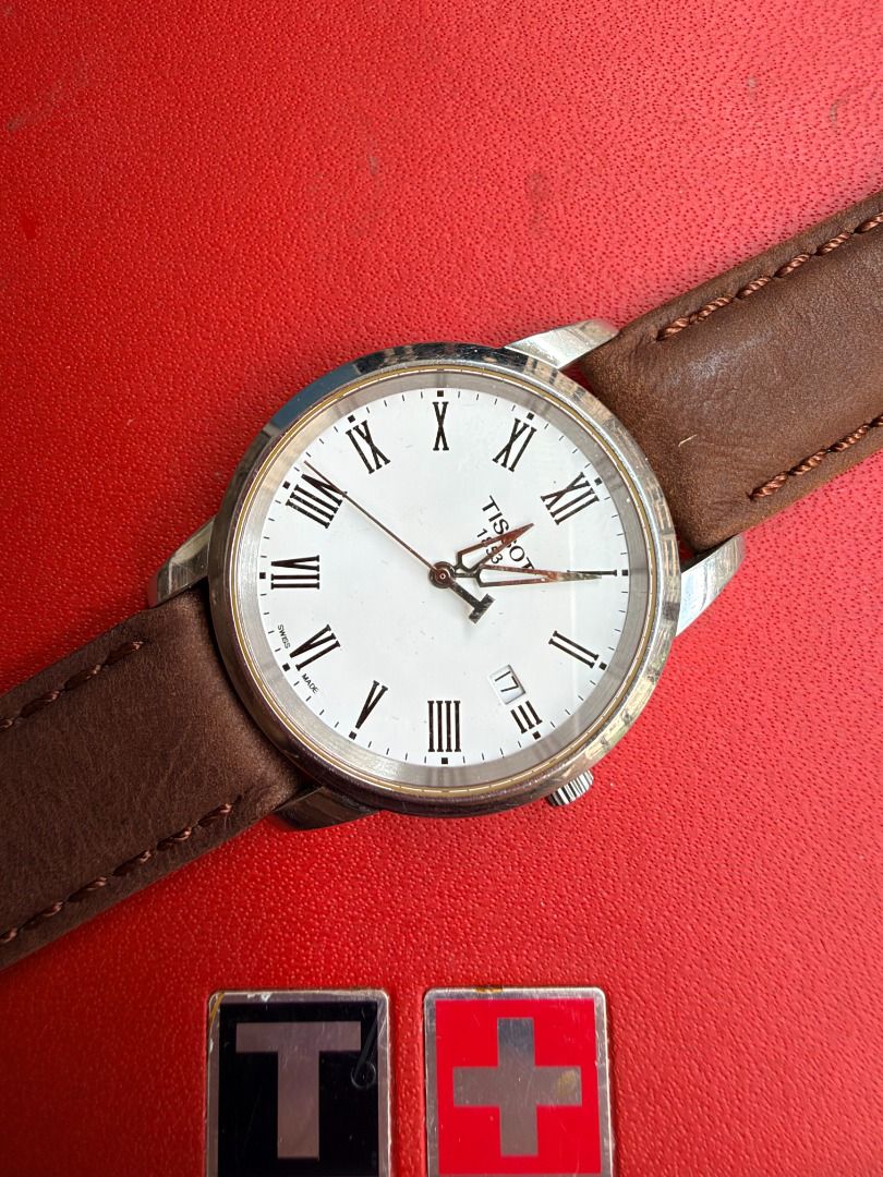 Tissot 1853 Classic Watch with Leather Strap (Category: Men's Watches) located in Quezon City. Submitted by 30somethingtreasures (Listing ID 1467991908, Image 2). Description: - Brand: Tissot 1853 - Dial: White with Roman numerals and 4 o'clock date window - Strap: Genuine brown leather - Case Back: Stainless steel (Ref: T033410B, water-resistant) - Inclusion: Original Tissot red and black box - Condition: Well-maintained and ready to wear - Meet