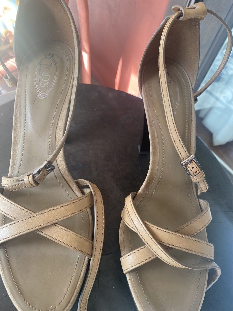 Tod's Tan Leather Platform High Heel Sandals Size 38 (Category: Heels) located in San Juan City. Submitted by ana.gpadilla (Listing ID 1467908162, Image 2). Description: - Brand: Tod's - Price: P5,000 -Retail Price: $500-$600 - Style: Strappy cross-toe platform heels with chunky heel - Color: Tan Material: leather - Size: 38.5 - Features: Adjustable ankle buckle and signature pebbled rubber sole grip - Condition: used only a handful of times. The