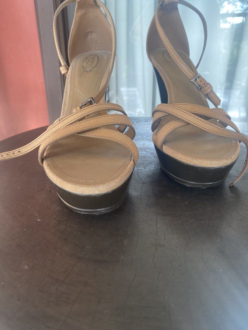 Tod's Tan Leather Platform High Heel Sandals Size 38 (Category: Heels) located in San Juan City. Submitted by ana.gpadilla (Listing ID 1467908162, Image 3). Description: - Brand: Tod's - Price: P5,000 -Retail Price: $500-$600 - Style: Strappy cross-toe platform heels with chunky heel - Color: Tan Material: leather - Size: 38.5 - Features: Adjustable ankle buckle and signature pebbled rubber sole grip - Condition: used only a handful of times. The
