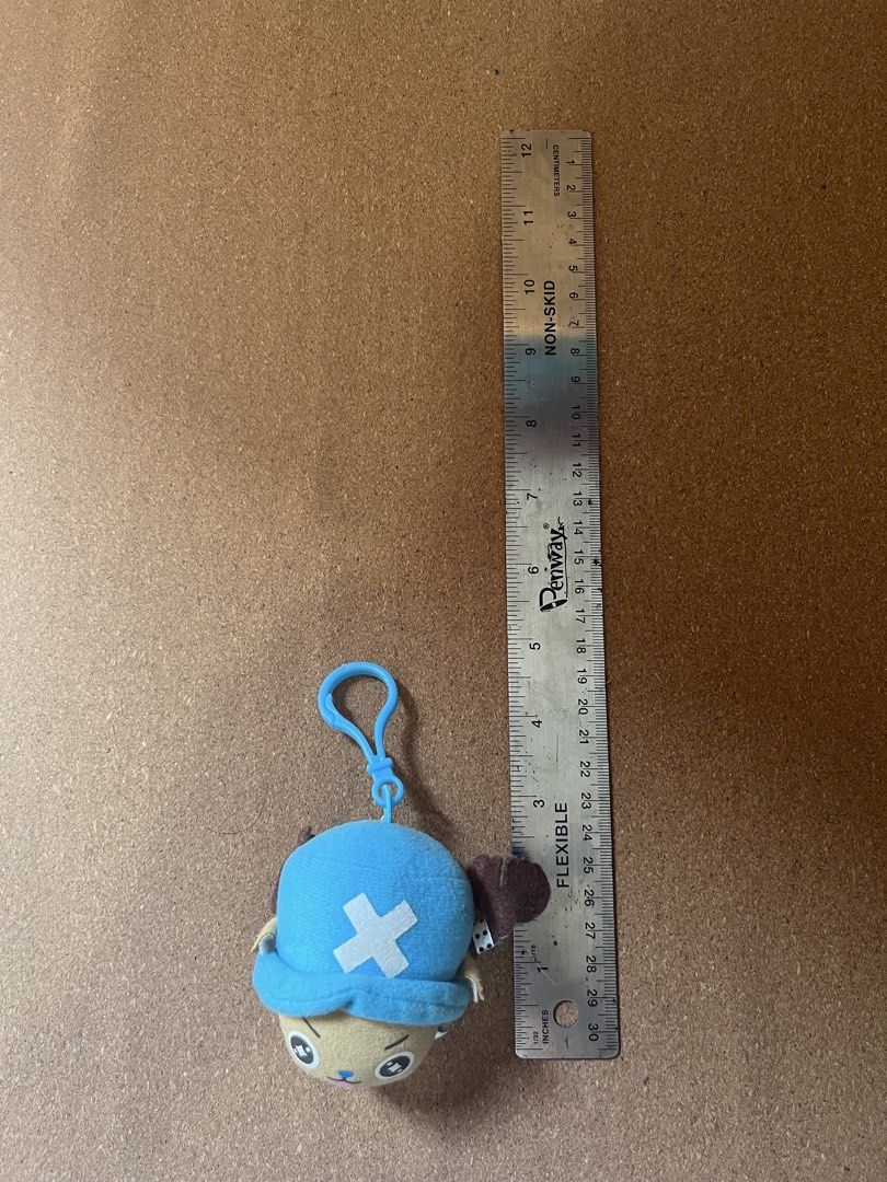 Tony Tony Chopper One Piece Plush Keychain (Category: Plushies & Soft Toys) located in Baguio. Submitted by gaara1234 (Listing ID 1467857647, Image 1). Description: - Character: Tony Tony Chopper from One Piece - Design: Blue hat with white cross, light brown face, and dark brown antlers - Size: Roughly 4 inches tall (including the strap) - Hardware: Includes a blue plastic clasp for easy hanging on bags or keys - Condition: Excellent, clean fabr