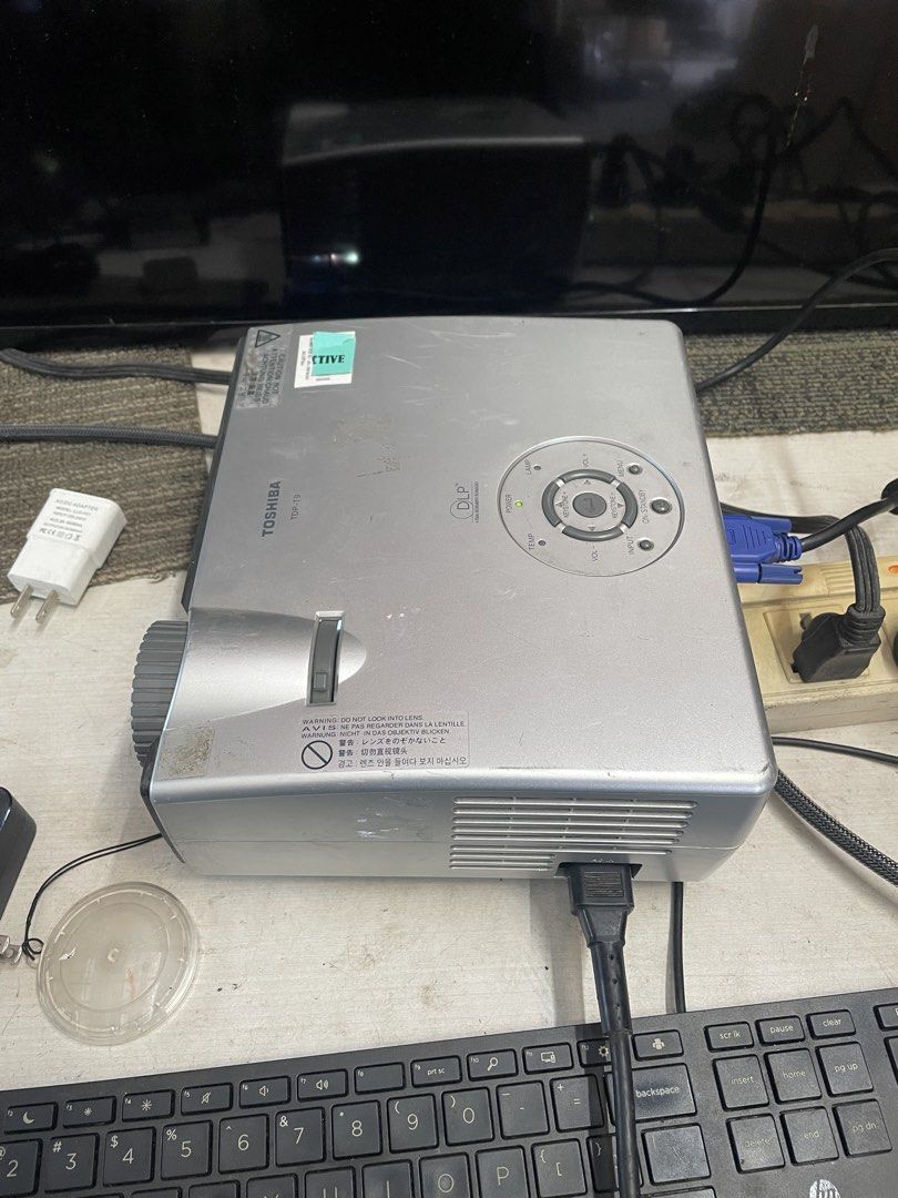 Toshiba TDP-T9 DLP Projector (Category: Projectors) located in Calamba. Submitted by jozamvibar76665 (Listing ID 1467861980, Image 2). Description: - Tested and working: Throws a bright, clear image perfect for movies and sports - Compact and portable design for easy setup anywhere - Condition: Normal cosmetic scuffs from past use, overall fully functional - Included accessories: Power cable, VGA cable, and attached lens cap - Connectivity: Monit