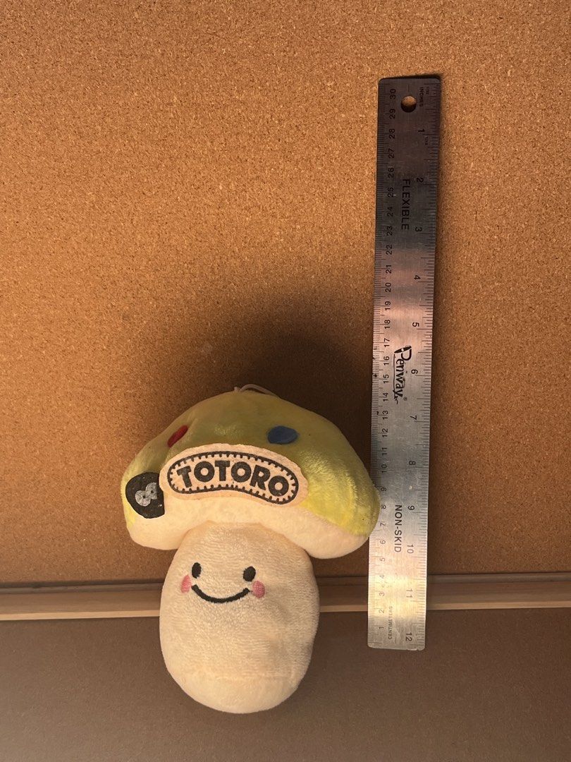 Totoro Mushroom Plush Toy (Category: Plushies & Soft Toys) located in Baguio. Submitted by gaara1234 (Listing ID 1467858470, Image 1). Description: - Adorable Totoro mushroom plush toy - Size: Approximately 11 cm in height - Design: Soft cream-colored body with a smiling expression, pink blush, and light green cap - Details: Features embroidered patches including a black soot sprite and 'Totoro' text - Feature: Includes an attached loop string at