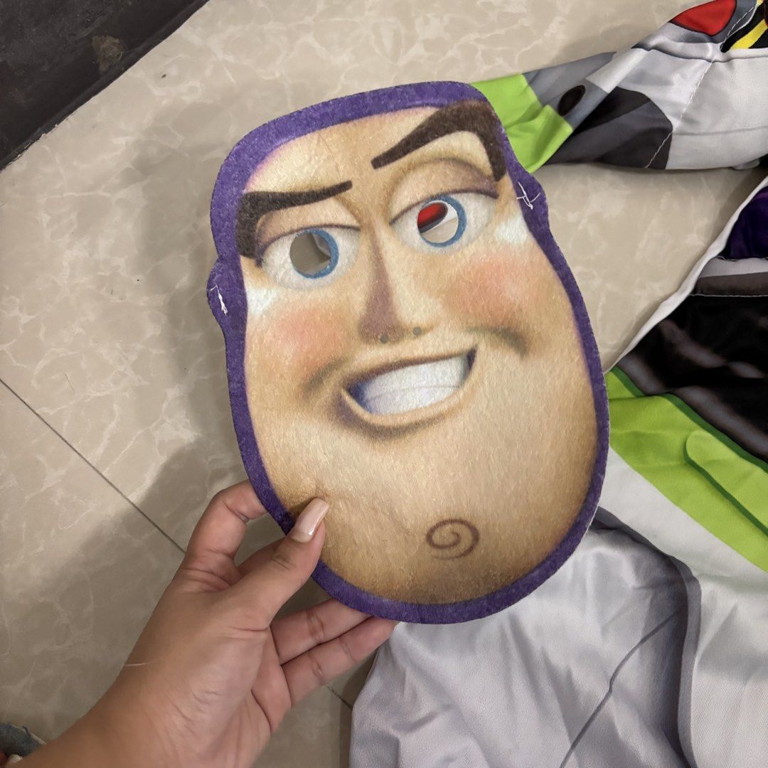Toy Story Buzz Lightyear Costume (Category: Babies & Kids Fashion) located in Makati City. Submitted by dianedelro (Listing ID 1467947903, Image 3). Description: - Toy Story Buzz Lightyear costume set - Full jumpsuit with printed control panel on chest and sleeves - Matching felt mask included - Separate printed belt with velcro attachment - Made from lightweight, comfortable fabric - Ideal for Halloween, birthdays, and dress-up parties.
