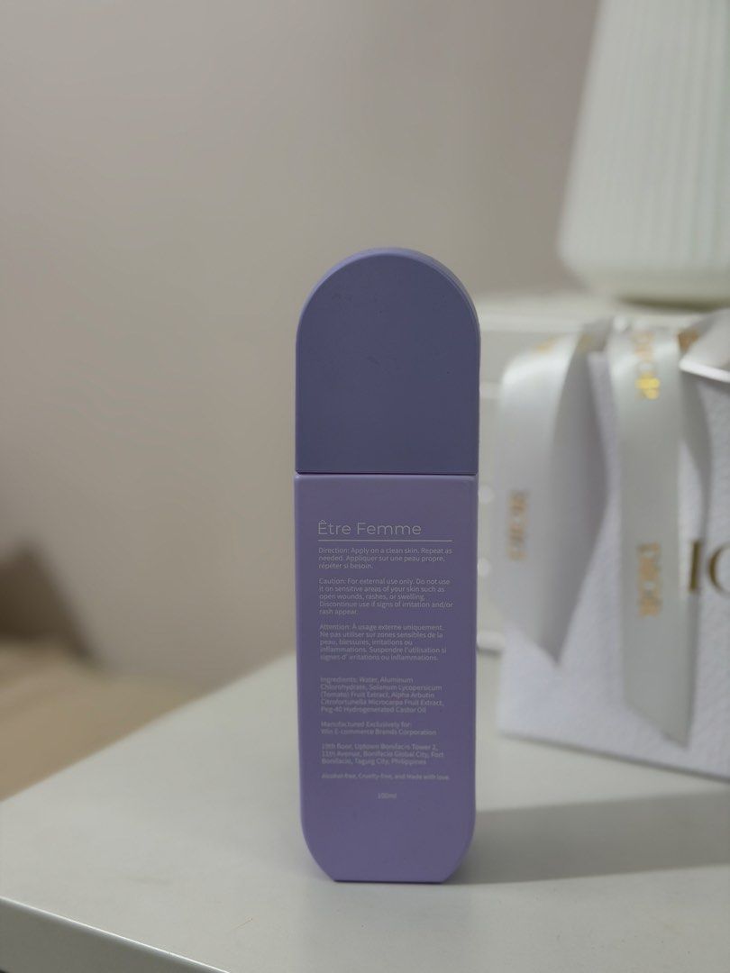 Être Femme Deodorant Spray (Category: Fragrance & Deodorants) located in Mandaluyong City. Submitted by notmichaela (Listing ID 1467909258, Image 2). Description: 90% full - Brand/Product: Être Femme Brightening Antiperspirant Spray - Size: 100ml (Purple packaging) - Benefits: Controls perspiration, eliminates odor, and helps brighten skin - Key Ingredients: Tomato fruit extract and alpha arbutin - Formula: Alcohol-free and cruelty-free - Manufac