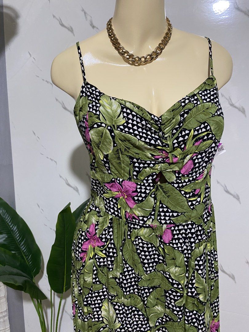 Tropical Leaf Print Spaghetti Strap Summer Dress (Category: Dresses) located in Taguig. Submitted by dinoswear.ph (Listing ID 1467855911, Image 3). Description: - Design: Green and black tropical leaf print with pink floral accents and geometric backdrop - Fit: Sweetheart neckline, adjustable spaghetti straps, and comfy smocked elastic back panel - Details: Front keyhole cutout and flattering ruched bust - Length: Flared knee-length skirt - Mater