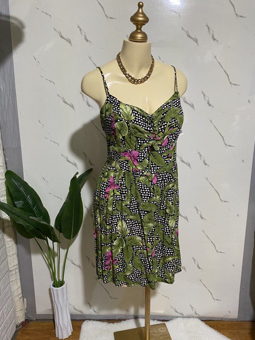 Tropical Leaf Print Spaghetti Strap Summer Dress (Category: Dresses) located in Taguig. Submitted by dinoswear.ph (Listing ID 1467855911, Image 2). Description: - Design: Green and black tropical leaf print with pink floral accents and geometric backdrop - Fit: Sweetheart neckline, adjustable spaghetti straps, and comfy smocked elastic back panel - Details: Front keyhole cutout and flattering ruched bust - Length: Flared knee-length skirt - Mater