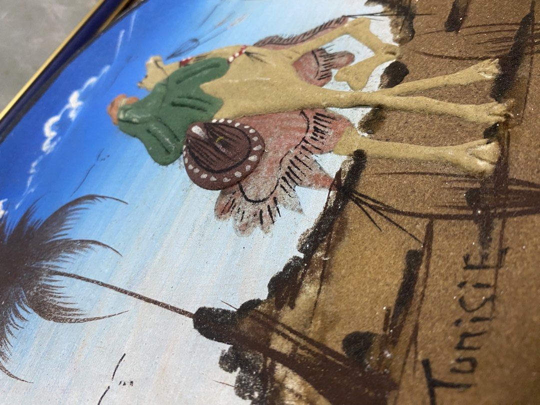 Tunisian Sand Art Decorative Plate Camel Design (Category: Wall Decor) located in Calamba. Submitted by chebvintagedepot (Listing ID 1467933147, Image 3). Description: (B19-04)Hand-Painted Tunisian Decorative Wall Plate – Camel Desert Scene Decorative Tunisian wall plate or plaque made from terra cotta or ceramic, featuring a raised 3D desert scene with a person riding a camel and a palm tree. The word “Tunisie” is painted along the bottom. The h