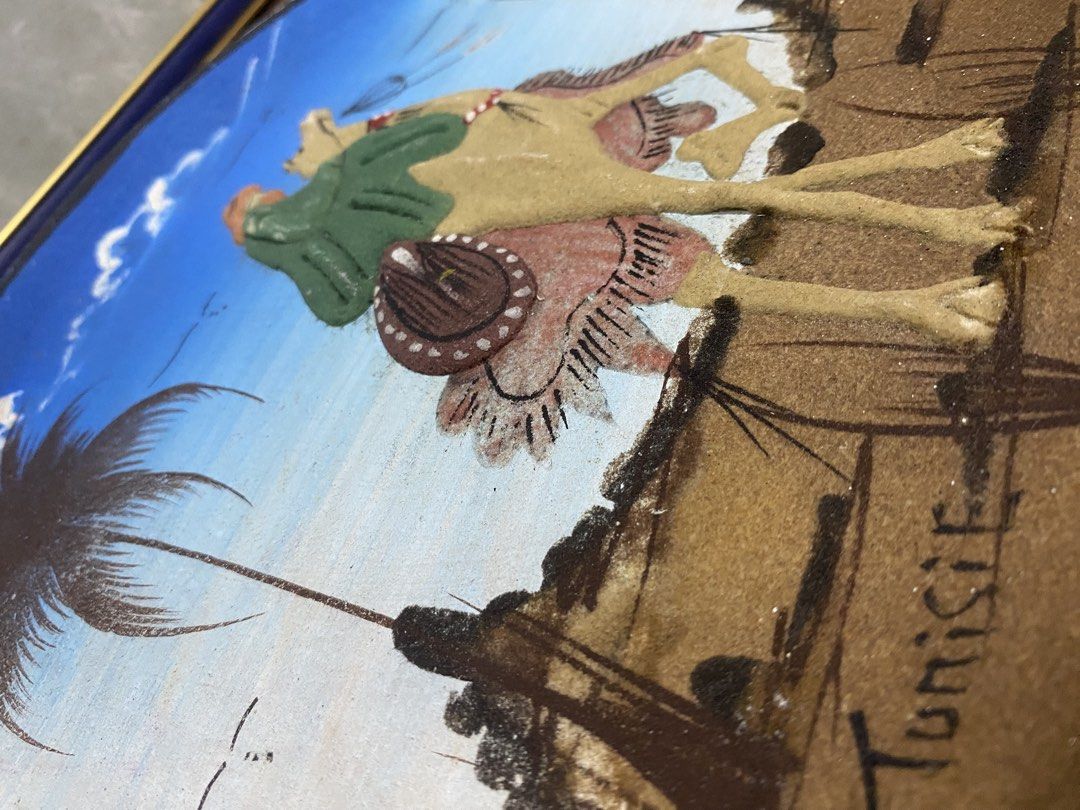 Tunisian Sand Art Decorative Plate Camel Design (Category: Wall Decor) located in Calamba. Submitted by chebvintagedepot (Listing ID 1467933147, Image 2). Description: (B19-04)Hand-Painted Tunisian Decorative Wall Plate – Camel Desert Scene Decorative Tunisian wall plate or plaque made from terra cotta or ceramic, featuring a raised 3D desert scene with a person riding a camel and a palm tree. The word “Tunisie” is painted along the bottom. The h
