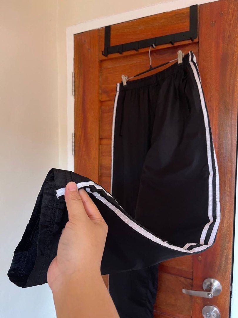 Two lines Track Pants (Category: Other Bottoms) located in Baler. Submitted by definitelynotmics (Listing ID 1467847134, Image 2). Description: FOR SALE TWO LINES TRACK PANTS WITH DRAWSTRING AND SIDE POCKETS COLOR BLACK WITH WHITE LINES IN EXCELLENT CONDITION COLOR RATE 9/10 CAN FIT SIZE 25 TO 35 WAISTLINE LENGTH 40.5 INCHES UNISEX STRETCHABLE GARTERIZED WAIST WITH MINIMAL FLAWS KINDLY CHECK THE PHOTOS FOR THE COMPLETE DETAILS SUPER NICE IN ACTUA