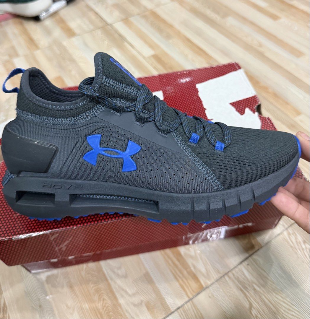 Under Armour HOVR Phantom Running Shoes (Category: Sneakers) located in Tabuk. Submitted by farawayluxe (Listing ID 1468043912, Image 1). Description: - Brand: Under Armour - Model: HOVR Phantom - Color: Black and Blue - Size: Men’s 7.5 or Women’s 8.5 - Upper: Breathable knit material with responsive cushioning - Outsole: Textured rubber for solid grip on runs and gym sessions - Condition: Complete with original box packaging - Ideal for: Running