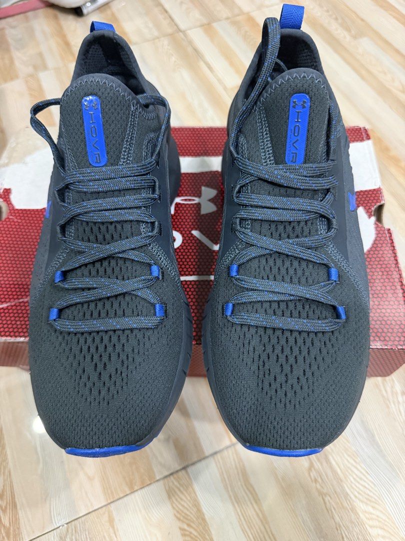 Under Armour HOVR Phantom Running Shoes (Category: Sneakers) located in Tabuk. Submitted by farawayluxe (Listing ID 1468043912, Image 3). Description: - Brand: Under Armour - Model: HOVR Phantom - Color: Black and Blue - Size: Men’s 7.5 or Women’s 8.5 - Upper: Breathable knit material with responsive cushioning - Outsole: Textured rubber for solid grip on runs and gym sessions - Condition: Complete with original box packaging - Ideal for: Running
