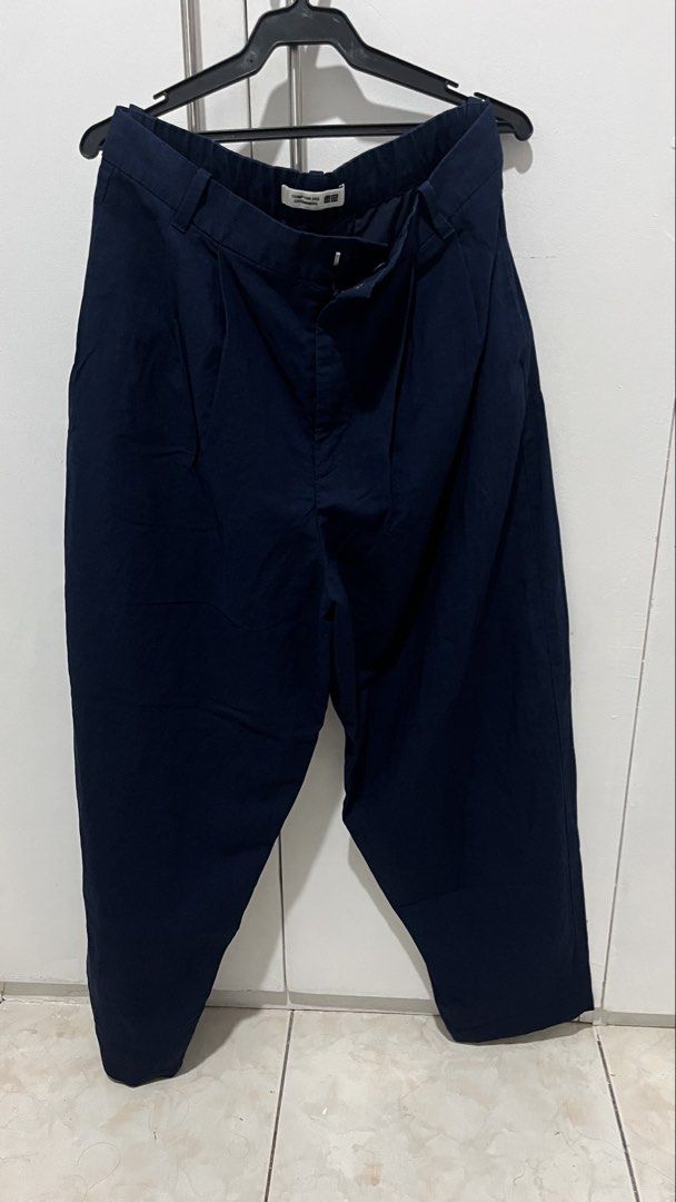 Uniqlo Navy Pleated Trousers (Category: Other Bottoms) located in Makati City. Submitted by bsotelo (Listing ID 1468007654, Image 2). Description: - Brand: Comptoir des Cotonniers x Uniqlo - Color: Deep navy blue - Size: XL - Fit: High waist with front pleats and wide relaxed legs - Closure: Zip fly with hook and bar, plus elastic waistband at the back for extra comfort - Condition: Clean, neatly hung, excellent pre-loved condition.